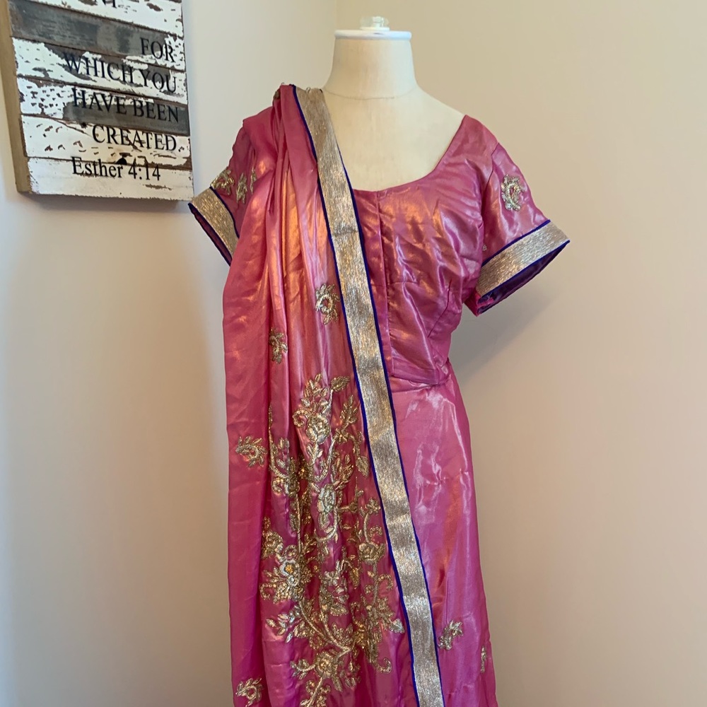 Pink silk sari with gold embroidered detail.